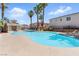 Lovely community pool, perfect for relaxation, with surrounding palm trees and lounge chairs at 9572 Belle Rich St, Las Vegas, NV 89123