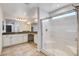 Bathroom features a walk in shower with glass doors, double sinks and neutral paint at 10556 Sariah Skye Ave, Las Vegas, NV 89166