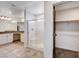 Bathroom featuring a walk in shower with glass doors, double sinks and walk in closet at 10556 Sariah Skye Ave, Las Vegas, NV 89166