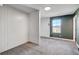 This bedroom features grey carpet and walls with white wooden accent wall at 10556 Sariah Skye Ave, Las Vegas, NV 89166