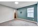 Carpeted bedroom with two-tone walls, bright natural light, and a mounted bracket at 10556 Sariah Skye Ave, Las Vegas, NV 89166