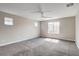 Spacious primary bedroom features soft carpeting, neutral paint and natural light from three windows at 10556 Sariah Skye Ave, Las Vegas, NV 89166