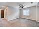 Spacious bedroom features gray carpet, a ceiling fan and natural light from the window at 10556 Sariah Skye Ave, Las Vegas, NV 89166