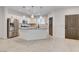 Bright kitchen with stainless steel appliances, center island with granite countertops, and wood look floors at 10556 Sariah Skye Ave, Las Vegas, NV 89166