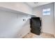 Efficient laundry area equipped with a modern washer/dryer and storage shelf at 10556 Sariah Skye Ave, Las Vegas, NV 89166