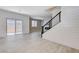 Bright living room with wood-look tile floors, shiplap wall, staircase and sliding glass doors to the patio at 10556 Sariah Skye Ave, Las Vegas, NV 89166