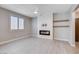 Bright living room featuring a modern fireplace, shelves and big window at 10556 Sariah Skye Ave, Las Vegas, NV 89166