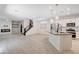 Spacious open-concept living area with modern fireplace, kitchen island, and wood look flooring at 10556 Sariah Skye Ave, Las Vegas, NV 89166