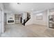 Open living space featuring wood-look tile floors, modern fireplace with shiplap wall and a staircase at 10556 Sariah Skye Ave, Las Vegas, NV 89166