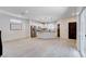 Open concept floorplan with living room and kitchen featuring stainless appliances and wood-look tile floors at 10556 Sariah Skye Ave, Las Vegas, NV 89166