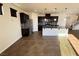 Open kitchen featuring stainless steel appliances, dark cabinetry, granite countertops, and a center island at 10715 York Manor Ave, Las Vegas, NV 89166