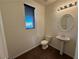Powder room with pedestal sink and dark flooring at 10715 York Manor Ave, Las Vegas, NV 89166