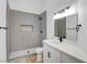 Modern bathroom with walk-in shower featuring gray tile, contemporary vanity, and matte black fixtures at 116 Lotus Blossom Ct, Las Vegas, NV 89145