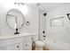 Clean bathroom featuring tub with white marble-style tile surround, and modern fixtures at 116 Lotus Blossom Ct, Las Vegas, NV 89145