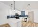 Modern kitchen with white cabinets, stainless steel appliances, blue backsplash, and quartz countertops at 116 Lotus Blossom Ct, Las Vegas, NV 89145