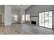 Spacious living room with fireplace, sliding glass doors, and wood-look flooring at 116 Lotus Blossom Ct, Las Vegas, NV 89145