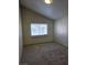 Bedroom featuring neutral carpet, window allowing for natural light and vaulted ceiling at 1739 N Lamont St, Las Vegas, NV 89115