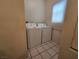 Tiled laundry room area with a washer and dryer and a window for natural light at 1739 N Lamont St, Las Vegas, NV 89115