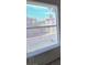 The window looks out to the neighborhood street and buildings across from the home at 1739 N Lamont St, Las Vegas, NV 89115