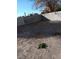 An open dirt backyard with a concrete wall. The open dirt area can be converted into grass or a garden at 1745 Starridge Way, Las Vegas, NV 89142