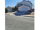 Two-story home featuring an attached two-car garage and separate garage on a sunny day at 1745 Starridge Way, Las Vegas, NV 89142
