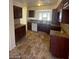A kitchen featuring wooden cabinets, tile countertops and flooring, and modern appliances at 1745 Starridge Way, Las Vegas, NV 89142