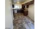A kitchen featuring wooden cabinets, tile countertops and flooring, and modern appliances at 1745 Starridge Way, Las Vegas, NV 89142