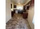 A kitchen featuring wooden cabinets, tile countertops and flooring, and modern appliances at 1745 Starridge Way, Las Vegas, NV 89142