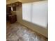 This kitchen features brown cabinets, dark countertops, neutral backsplash, and tile flooring at 1745 Starridge Way, Las Vegas, NV 89142
