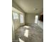 The living room features tile flooring and multiple windows for ample natural light at 1745 Starridge Way, Las Vegas, NV 89142