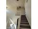 Carpeted staircase with white railing leading to the upper floor of the home at 1745 Starridge Way, Las Vegas, NV 89142