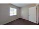 Simple bedroom with a large window and neutral-colored carpet at 1920 Lirio Way, Las Vegas, NV 89108
