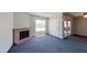 Cozy living room featuring a brick fireplace and sliding door to a balcony at 1920 Lirio Way, Las Vegas, NV 89108