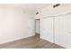 Bright bedroom with wood-look flooring, featuring ample closet space and multiple access doors at 200 W Sahara Ave # 2204, Las Vegas, NV 89102