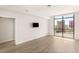 Cozy bedroom with hardwood floors, recessed lighting, and large window with city views at 200 W Sahara Ave # 2204, Las Vegas, NV 89102