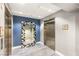 View of elevators on the 22nd floor, featuring modern finishes and a decorative mirror at 200 W Sahara Ave # 2204, Las Vegas, NV 89102