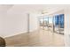 Bright living room with hardwood floors, ceiling fan, and floor-to-ceiling windows with city views at 200 W Sahara Ave # 2204, Las Vegas, NV 89102