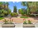 Lush backyard featuring a bridge over a koi pond, an artificial lawn and beautiful plantings at 226 Dalmatian Ln, Las Vegas, NV 89107