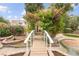 Charming backyard gazebo adorned with flowering vines, accessible by a quaint bridge over a serene water feature at 226 Dalmatian Ln, Las Vegas, NV 89107