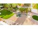 Mature landscaping with a gazebo, water feature, artificial turf, and a walking bridge in backyard at 226 Dalmatian Ln, Las Vegas, NV 89107
