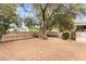 Secluded backyard featuring trees, shrubs, hardscape, and privacy fencing at 226 Dalmatian Ln, Las Vegas, NV 89107