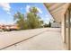 Large outdoor balcony with an overhang, offering a scenic view of neighborhood trees and blue skies at 226 Dalmatian Ln, Las Vegas, NV 89107