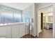 Featuring a soaking tub with a shower wand, sleek white cabinetry, and a view into the next bathroom at 226 Dalmatian Ln, Las Vegas, NV 89107