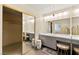 Elegant bathroom featuring dual sinks, stylish vanity, oversized mirror and tile flooring at 226 Dalmatian Ln, Las Vegas, NV 89107