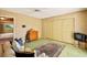Cozy bedroom showcasing green carpet, floral patterned walls, and a comfortable seating area at 226 Dalmatian Ln, Las Vegas, NV 89107