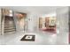 Elegant foyer with marble floors, a staircase, and an open floor plan to the dining area and beyond at 226 Dalmatian Ln, Las Vegas, NV 89107