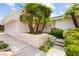 Welcoming entrance with a stone accent wall, mature landscaping, and a pathway leading to a double door entry at 226 Dalmatian Ln, Las Vegas, NV 89107