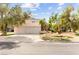 Charming home featuring a two-car garage, palm trees, and attractive landscaping, set against a clear sky at 226 Dalmatian Ln, Las Vegas, NV 89107