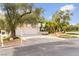 Charming home featuring a well-manicured lawn, mature trees and a spacious driveway leading to a two-car garage at 226 Dalmatian Ln, Las Vegas, NV 89107