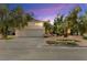 Charming home featuring a two-car garage, palm trees, and attractive landscaping, set against a colorful sky at 226 Dalmatian Ln, Las Vegas, NV 89107